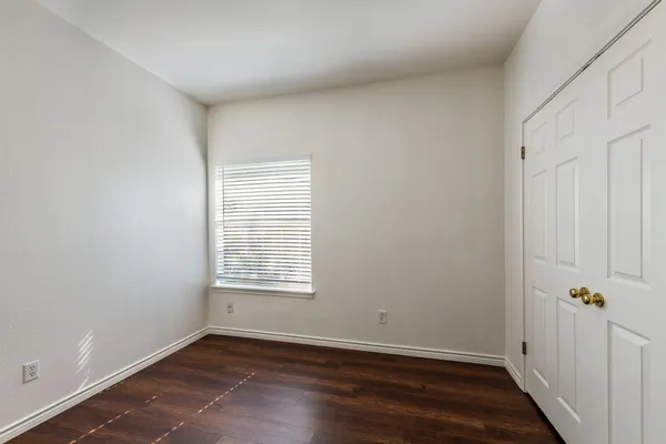 a view of an empty room and wooden floor