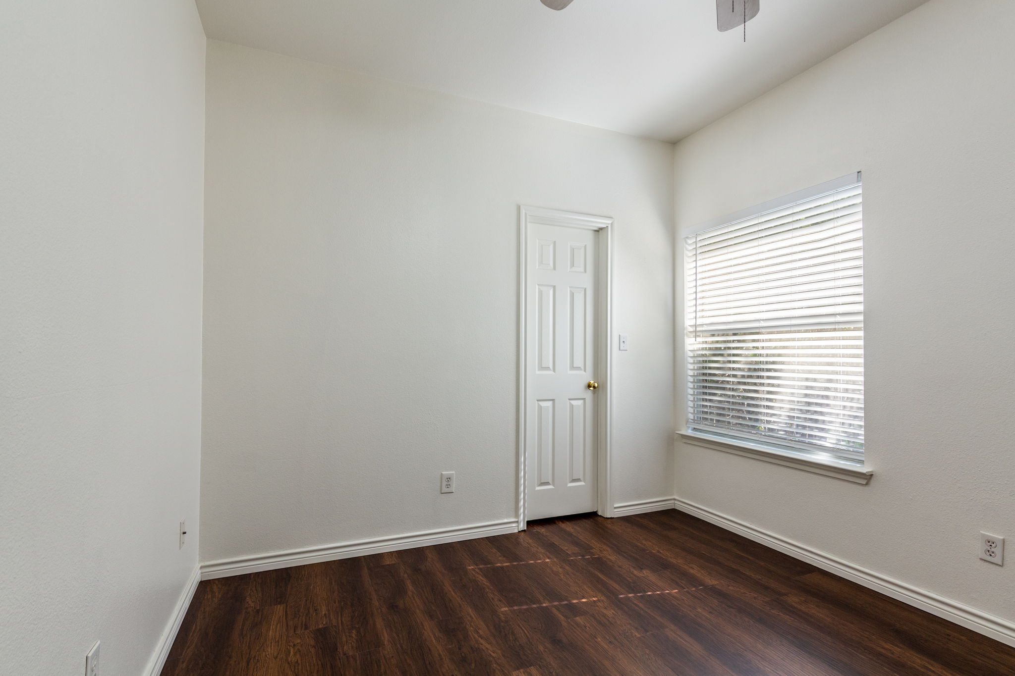 8708 Weiser Drive, Unit B Austin, TX 78729 - Photo 24 of 30 a view of an empty room with wooden floor and a window
