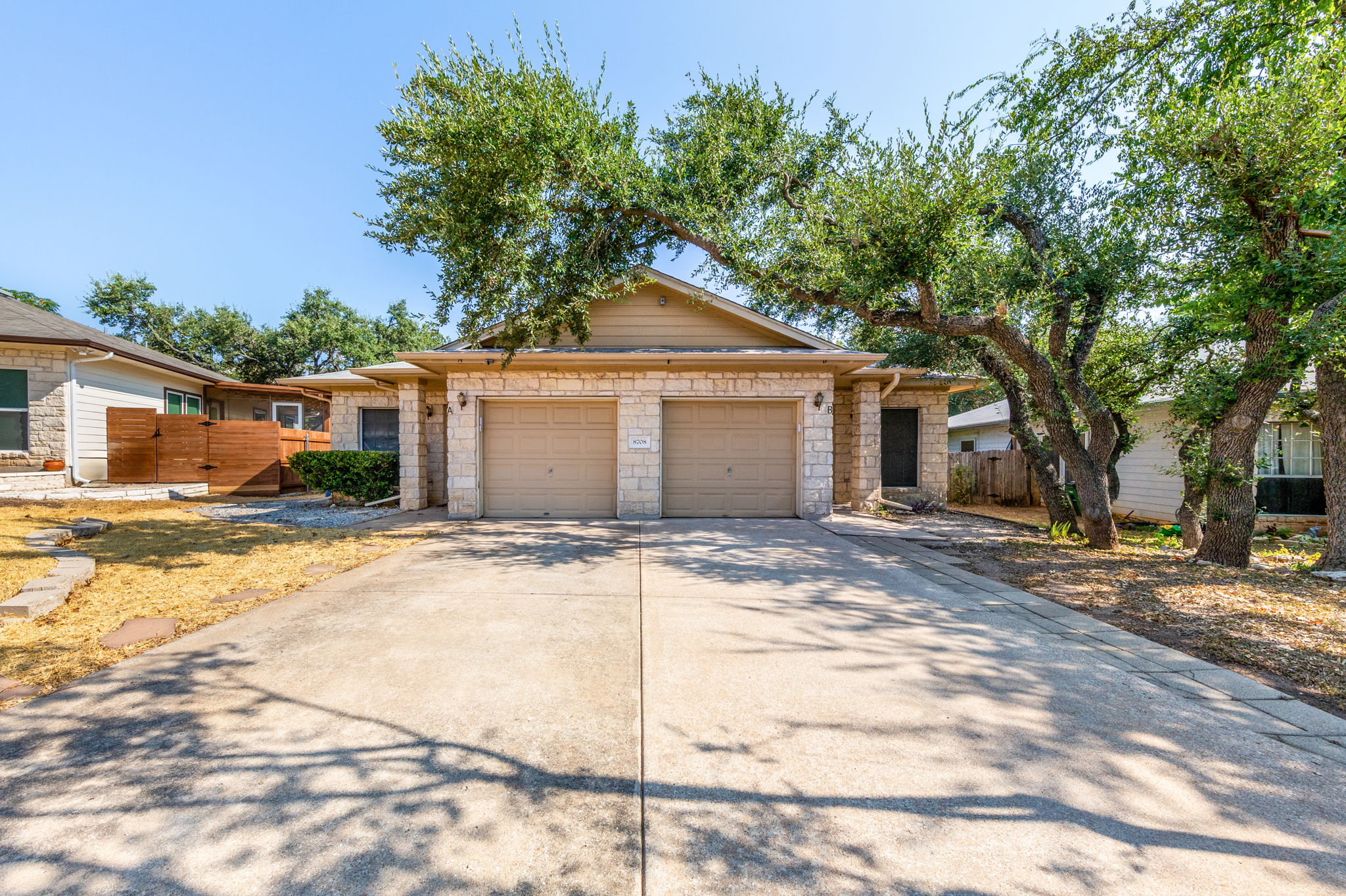 8708 Weiser Drive, Unit B Austin, TX 78729 - Photo 30 of 30 a house with trees in the background