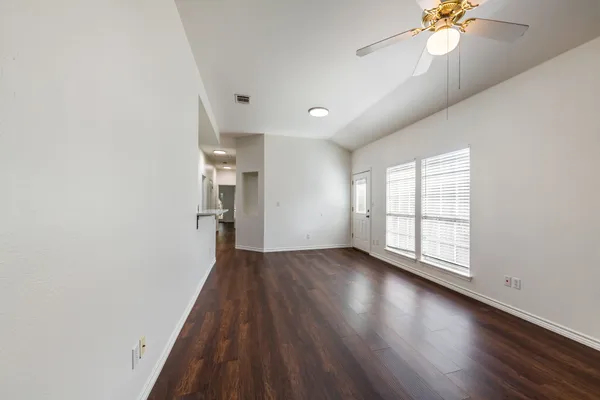 wooden floor in an empty room with a window