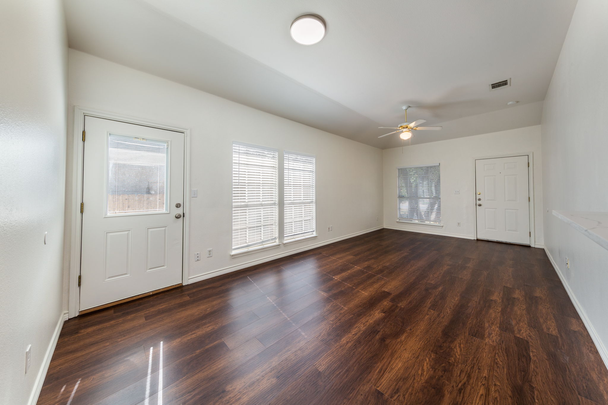 8708 Weiser Drive, Unit B Austin, TX 78729 - Photo 8 of 30 an empty room with wooden floor and windows
