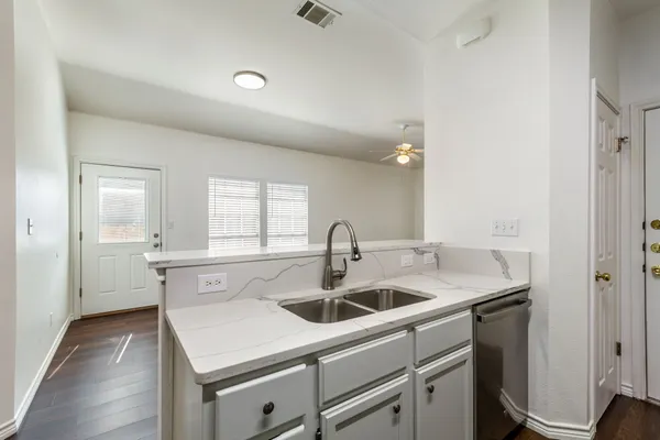 a kitchen with a sink and cabinets