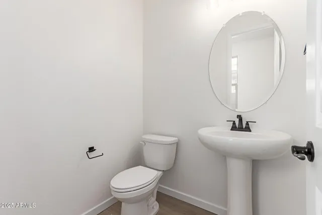 a view of a kitchen with a sink and dishwasher a refrigerator with wooden floor