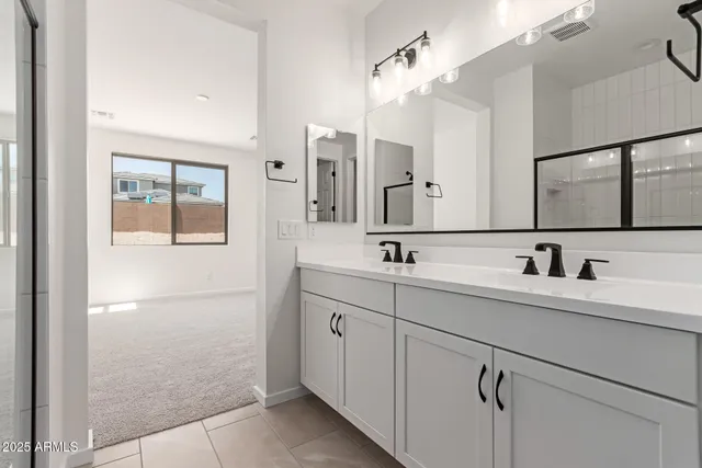 a bathroom with a double vanity sink mirror and
