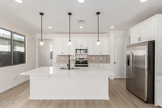 a kitchen with appliances and cabinets