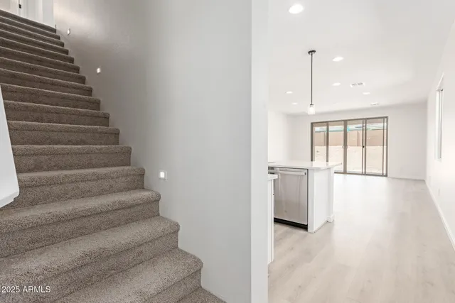 a kitchen with stainless steel appliances granite countertop a sink refrigerator and cabinets