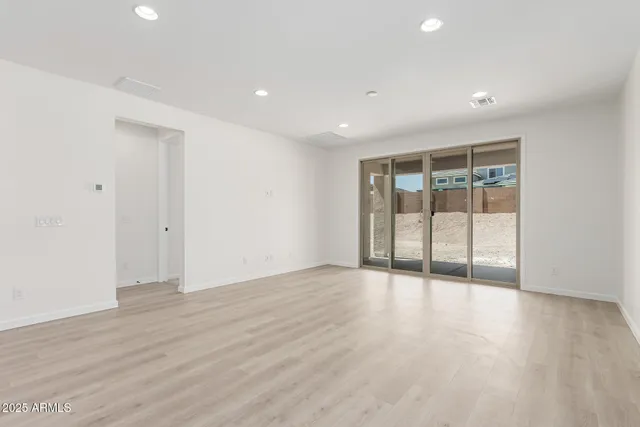 a view of an entryway with wooden floor