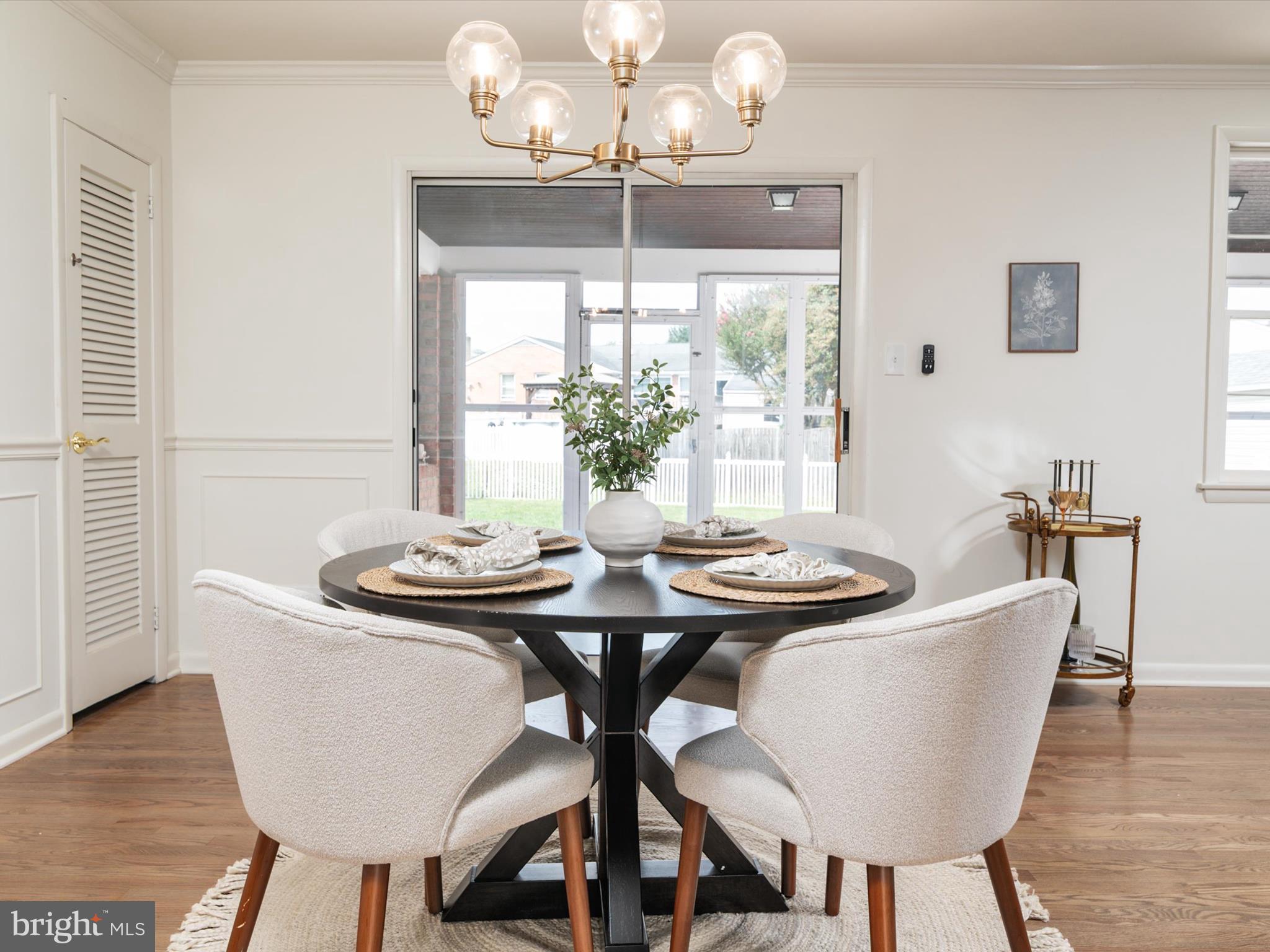 9212 Gardenia Road Baltimore, MD 21236 - Photo 11 of 44 a dining room with furniture a large window and wooden floor