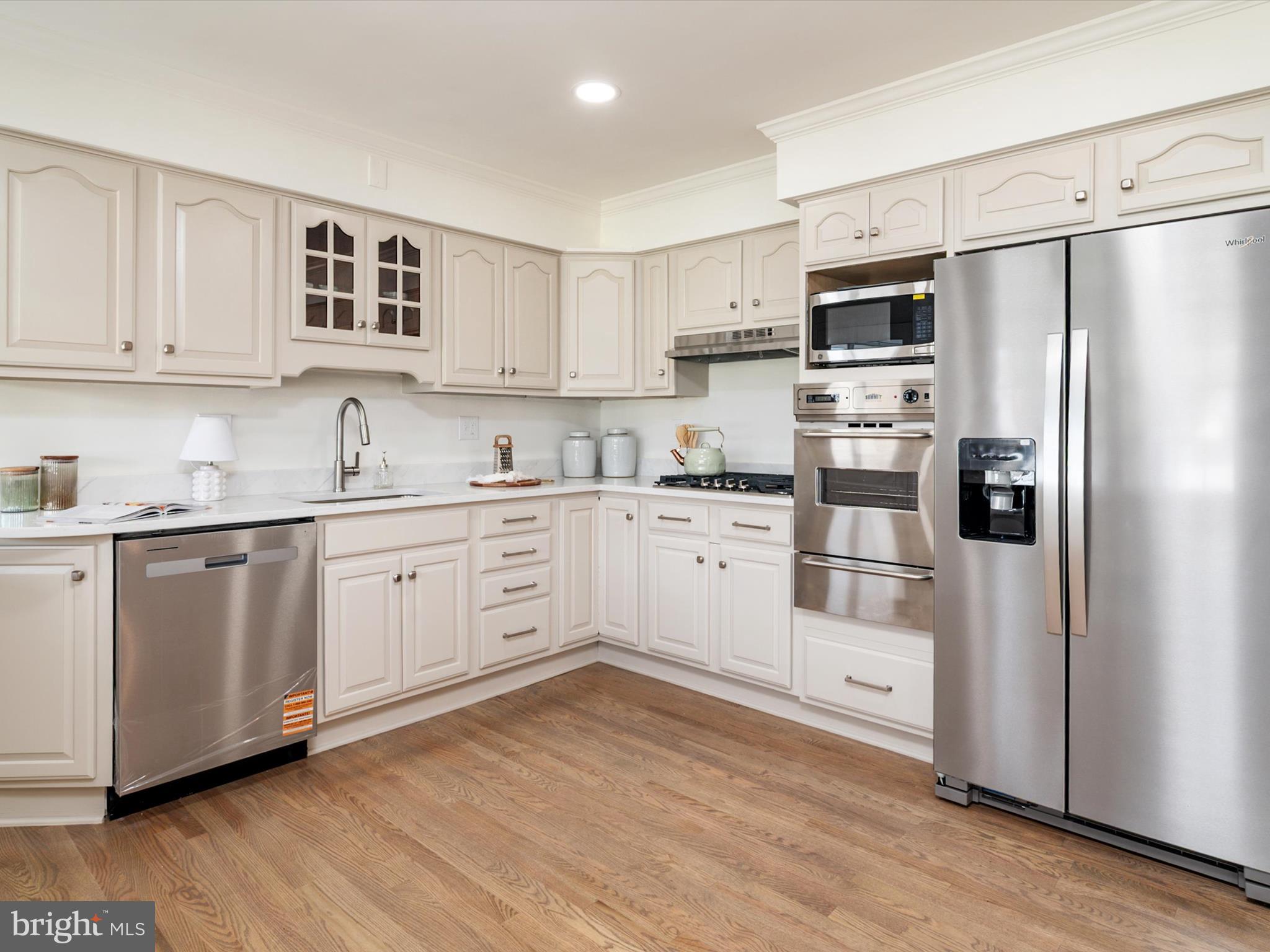 9212 Gardenia Road Baltimore, MD 21236 - Photo 14 of 44 a kitchen with white cabinets and white stainless steel appliances