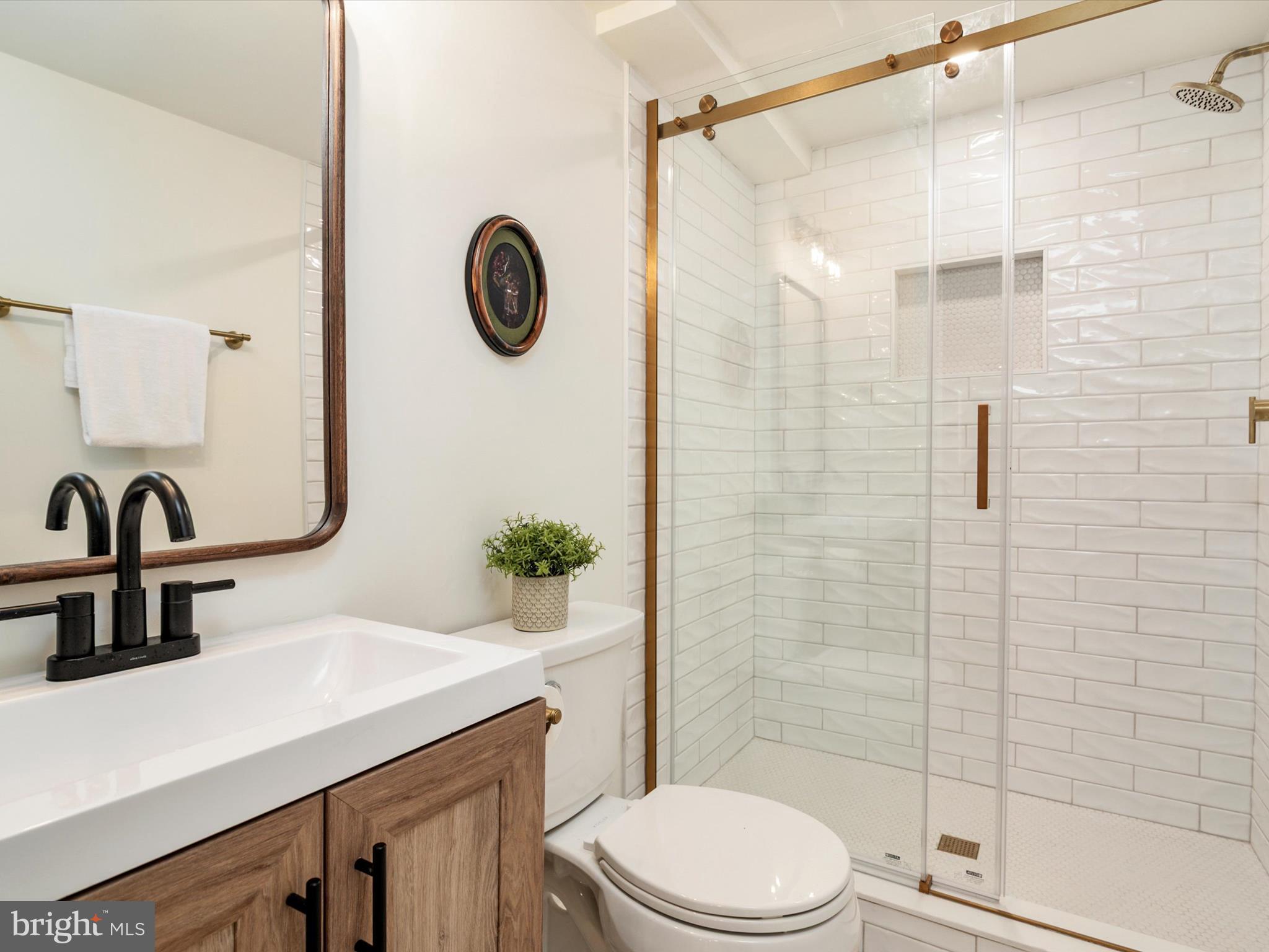 9212 Gardenia Road Baltimore, MD 21236 - Photo 31 of 44 a bathroom with a sink a toilet and shower