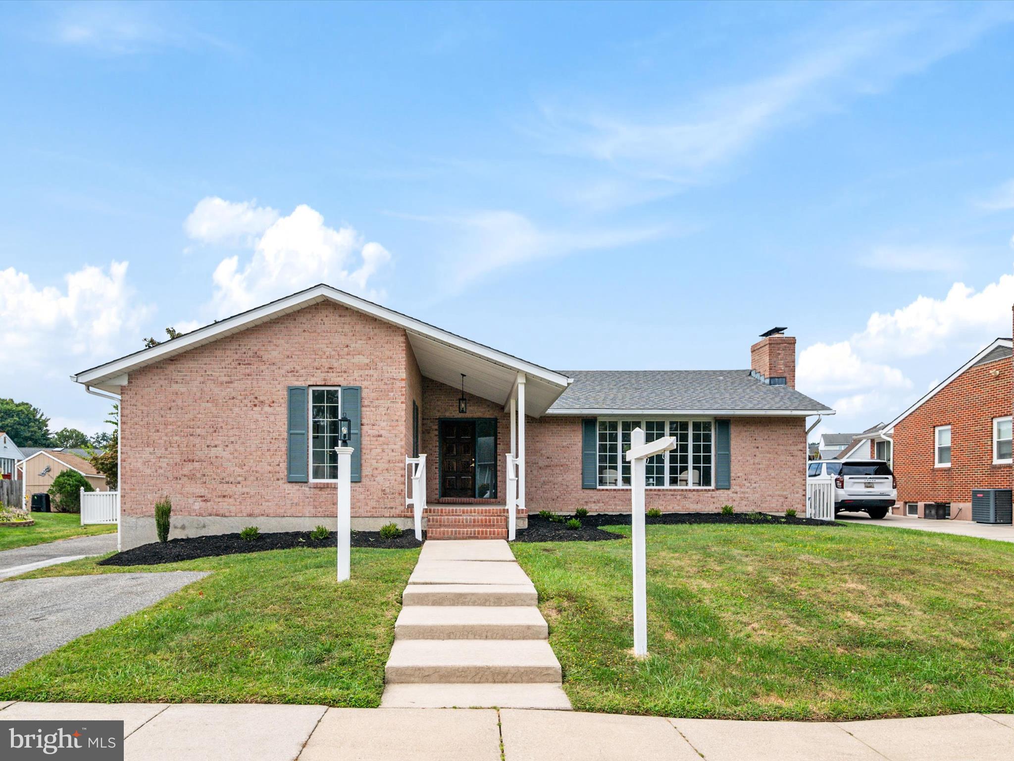 9212 Gardenia Road Baltimore, MD 21236 - Photo 4 of 44 a front view of a house with a yard