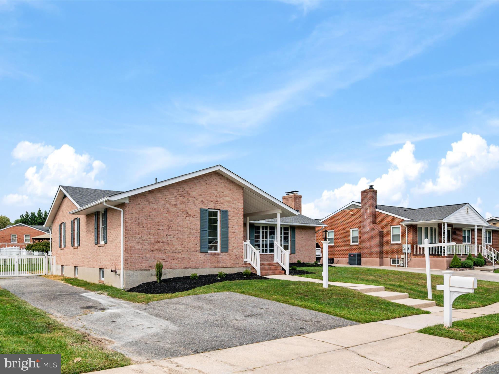 9212 Gardenia Road Baltimore, MD 21236 - Photo 42 of 44 a view of a white house next to a yard with big trees