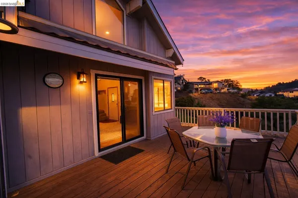a view of a chairs and table in the balcony