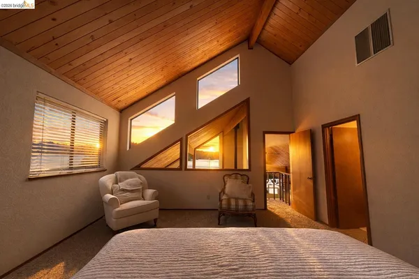 a bedroom with furniture and a window