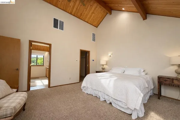 a bedroom with a bed and a couch