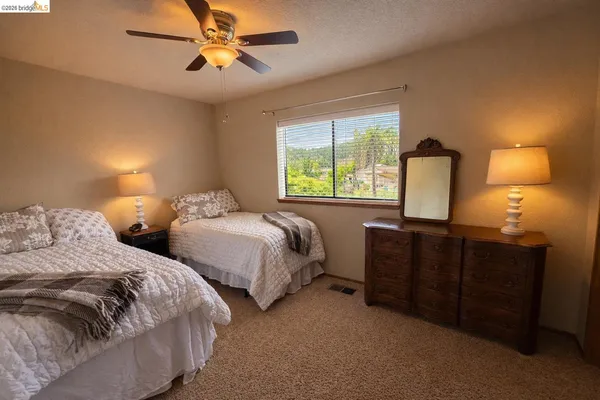 a bedroom with two beds and a chandelier