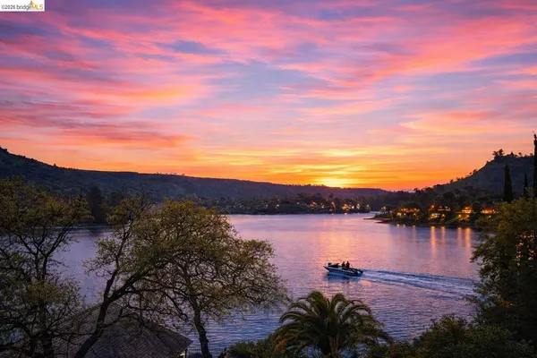 a view of a lake with houses in the back