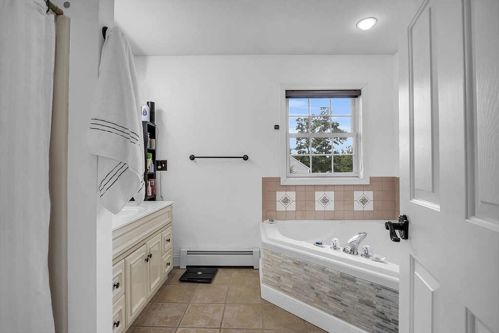22 French Road Templeton, MA 01468 - Photo 21 of 42 a bathroom with a tub sink and mirror