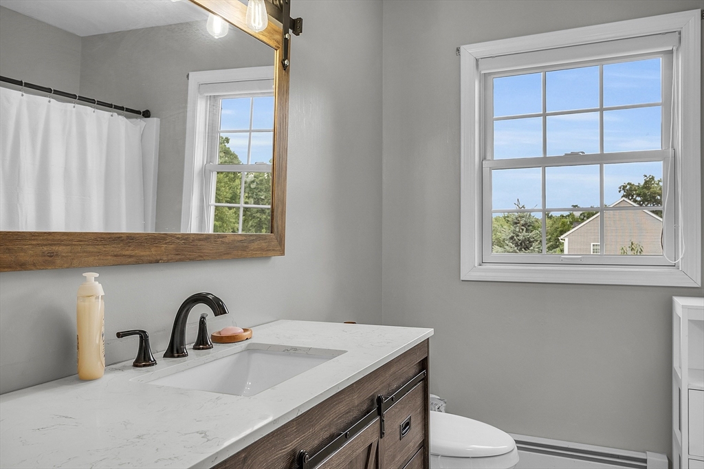 22 French Road Templeton, MA 01468 - Photo 29 of 42 a bathroom with a granite countertop sink a toilet and a window