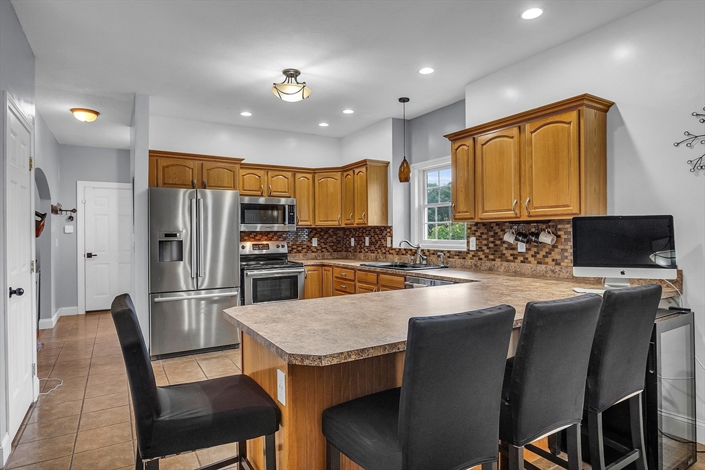 22 French Road Templeton, MA 01468 - Photo 10 of 42 a kitchen with stainless steel appliances granite countertop a refrigerator a stove a sink a dining table and chairs