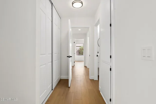 a view of a hallway with wooden floor