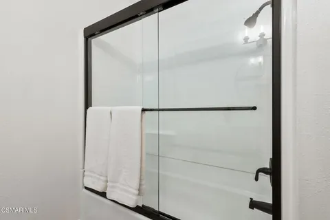a bathroom with a glass shower door
