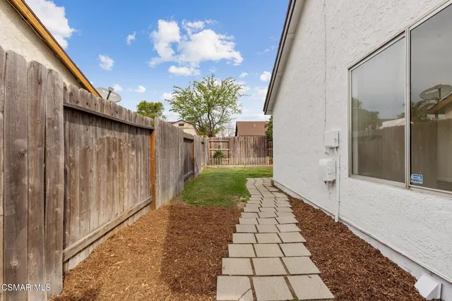 a view of a pathway both side of house