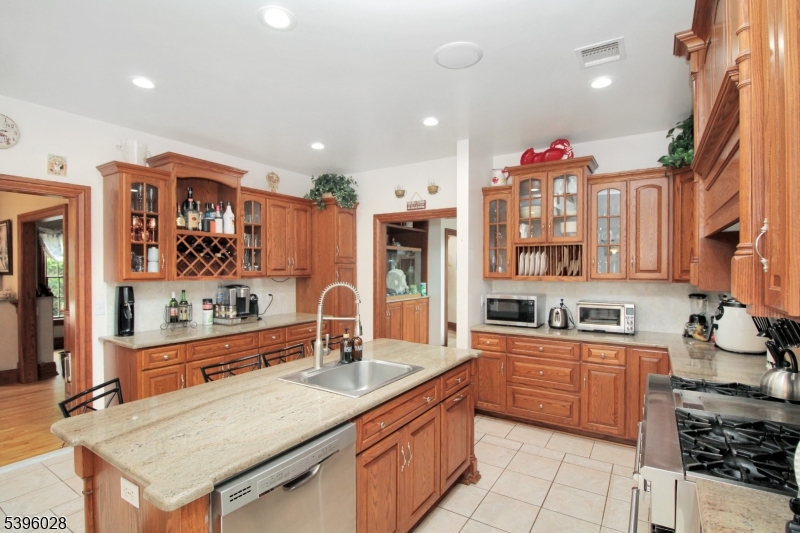 87 Walnut Valley Road Blairstown, NJ 07832 - Photo 11 of 33 a kitchen with granite countertop a sink stove and cabinets