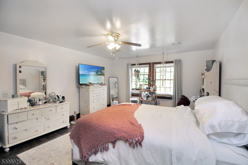 87 Walnut Valley Road Blairstown, NJ 07832 - Photo 20 of 33 a bedroom with a bed and a chandelier