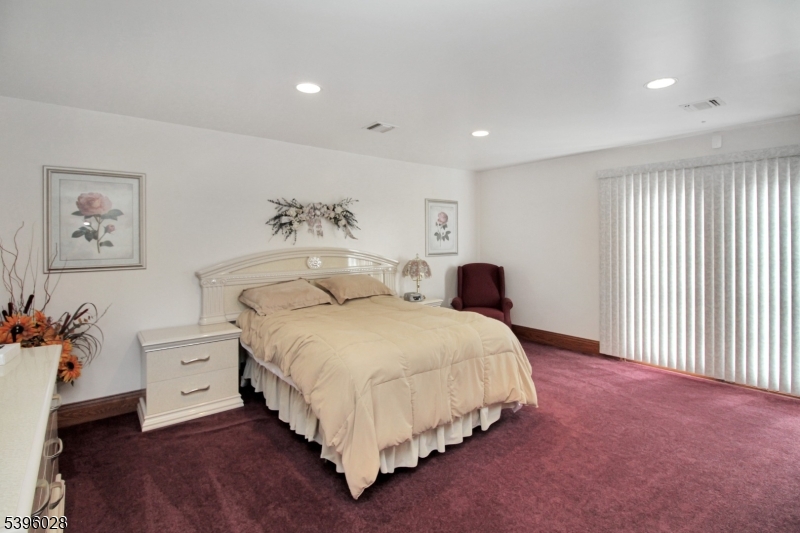 87 Walnut Valley Road Blairstown, NJ 07832 - Photo 22 of 33 a spacious bedroom with a bed and a couch