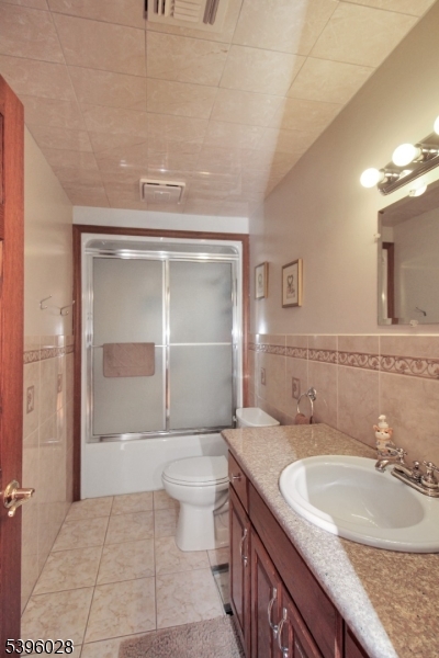 87 Walnut Valley Road Blairstown, NJ 07832 - Photo 24 of 33 a bathroom with a granite countertop sink a mirror and a bathtub