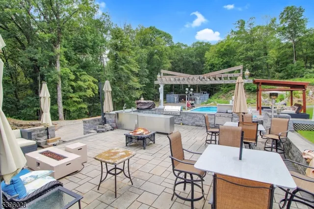 a view of a patio with a dining table and chairs with wooden floor
