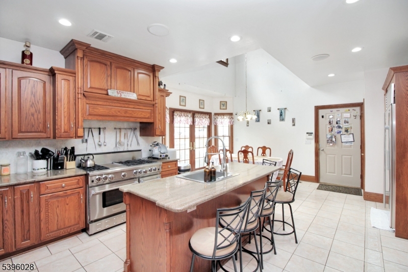 87 Walnut Valley Road Blairstown, NJ 07832 - Photo 9 of 33 a kitchen with a dining table cabinets and stainless steel appliances