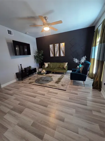 a living room with furniture and a flat screen tv