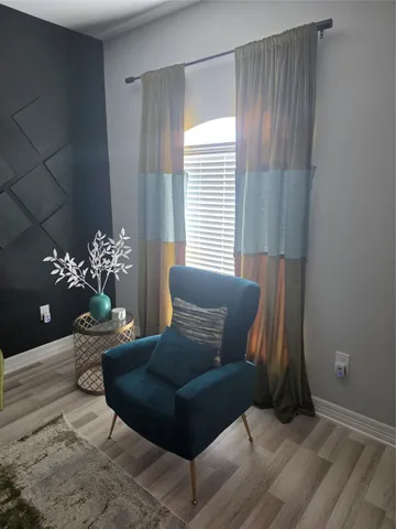 a living room with furniture and flowers