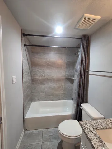 a bathroom with a toilet and a bathtub
