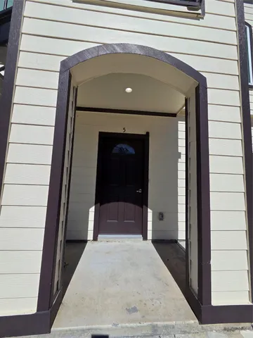 a front view of a house with a carpet