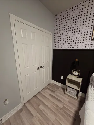 a bedroom with a bed and a television