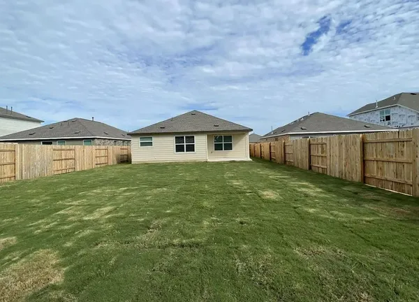 a view of a house with a yard and sitting area