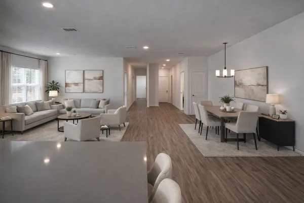 a living room with lots of furniture and view of kitchen