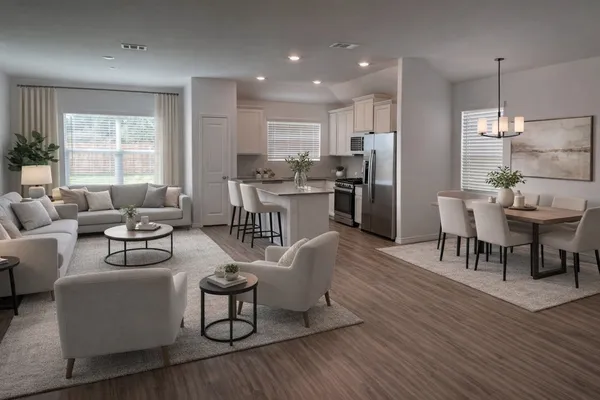 a living room with stainless steel appliances furniture and a wooden floor