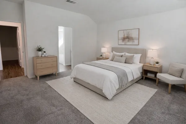a spacious bedroom with a bed and a couch