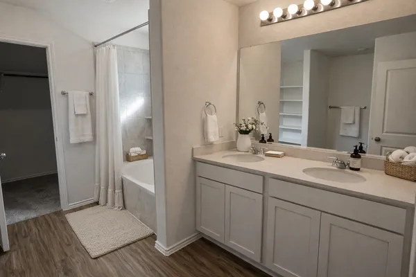 a bathroom with a double vanity sink and mirror