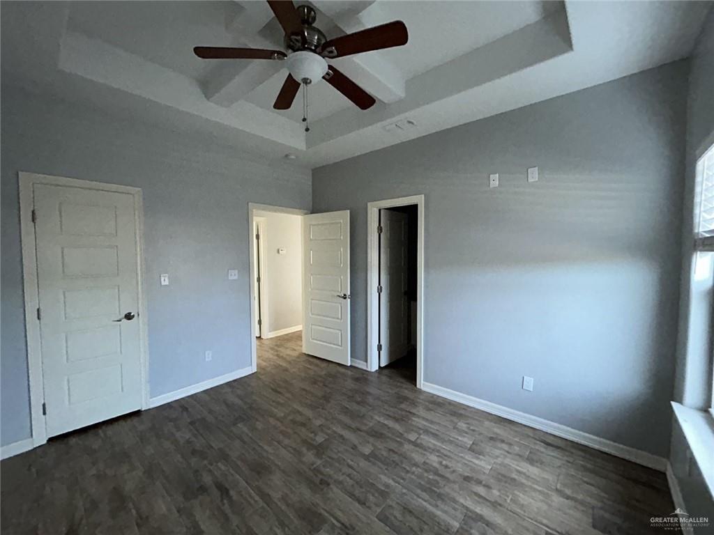 2100 Jackson Street, Unit 1 Weslaco, TX 78599 - Photo 5 of 13 an empty room with wooden floor and a ceiling fan
