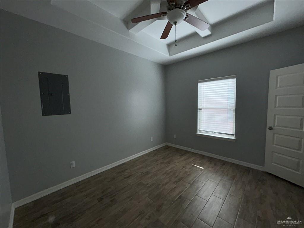 2100 Jackson Street, Unit 1 Weslaco, TX 78599 - Photo 9 of 13 an empty room with wooden floor ceiling fan and windows