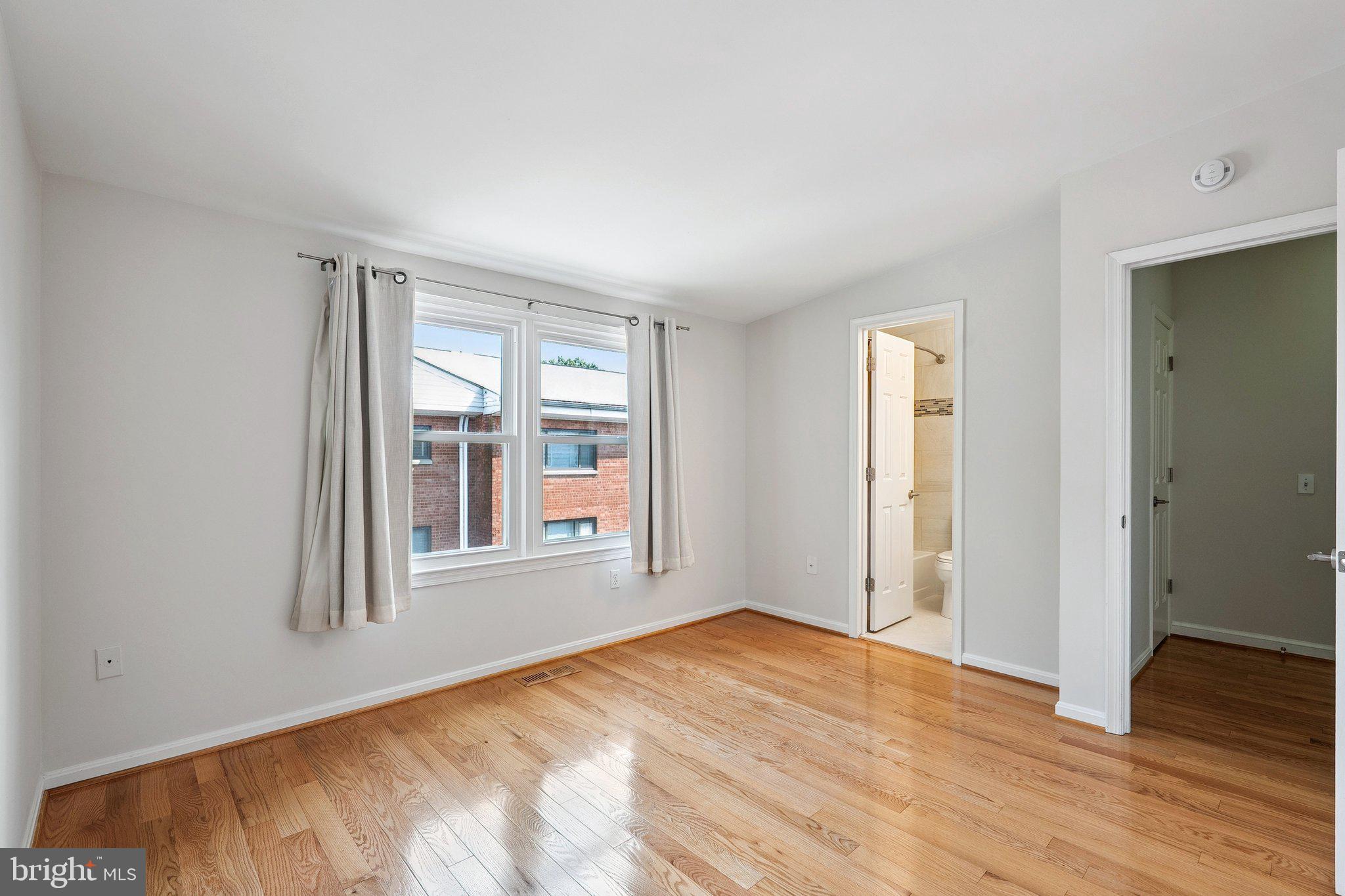 6861 Washington Boulevard Arlington, VA 22213 - Photo 14 of 28 an empty room with wooden floor and windows