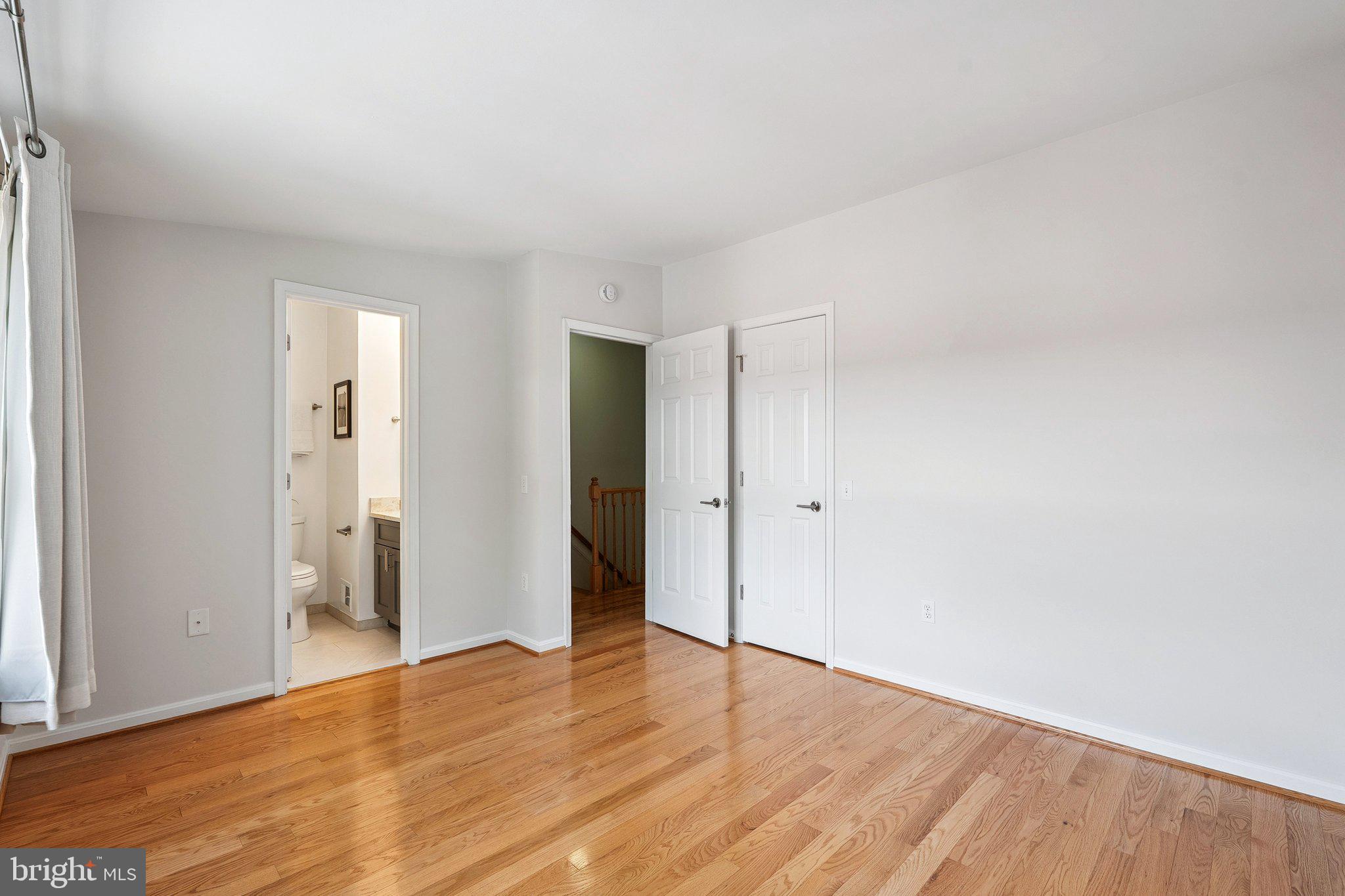 6861 Washington Boulevard Arlington, VA 22213 - Photo 15 of 28 a view of an empty room with wooden floor and closet