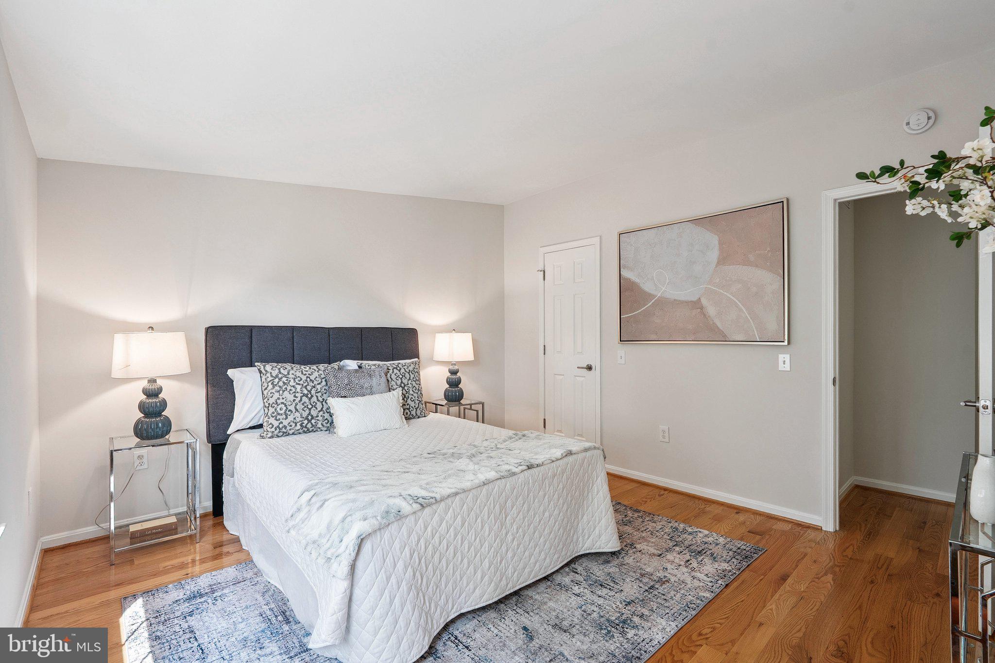 6861 Washington Boulevard Arlington, VA 22213 - Photo 18 of 28 a bedroom with a bed and wooden floor