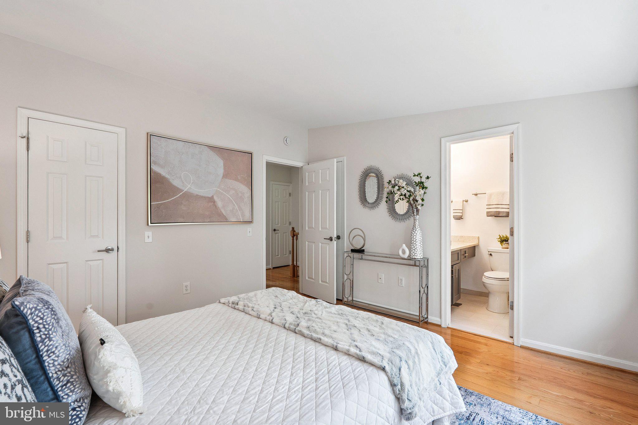 6861 Washington Boulevard Arlington, VA 22213 - Photo 19 of 28 a bedroom with a bed and a painting on the wall