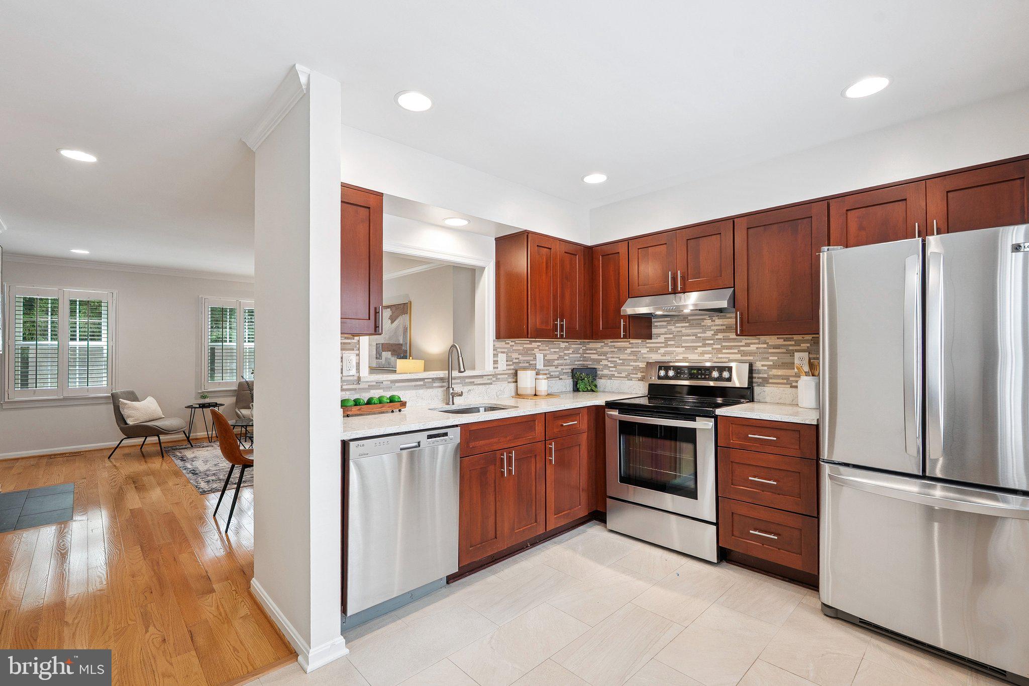 6861 Washington Boulevard Arlington, VA 22213 - Photo 2 of 28 a kitchen with stainless steel appliances granite countertop a refrigerator a stove top oven a sink and dishwasher